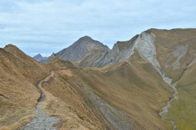 Mountain ridge with hiking trails around Brienzer Rothorn in autumn.