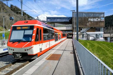Regional MGB train to Visp and Zermatt at the train station of Fiesch.