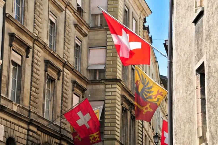 Swiss and cantonal flags in the Rue de l'Hotel de Ville in Geneva