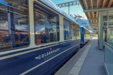 A GoldenPass Express train at the rail station of Gstaad.