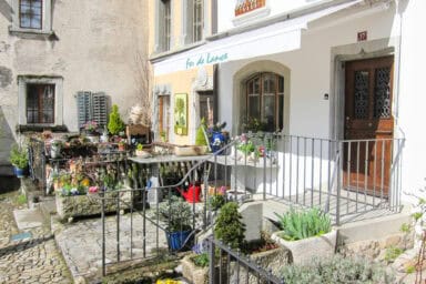 Colorful flowers adorning the streets and facades of Gruyères.