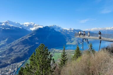 The Two Lakes Bridge at Harder Kulm in spring, with Lake Thun in the valley.
