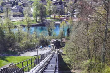 View down on the tracks, the valley station, and the river Aare from the Harder Kulm funicular.