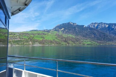 View of Lake Thun and the Niederhorn from the upper deck on a passenger boat.