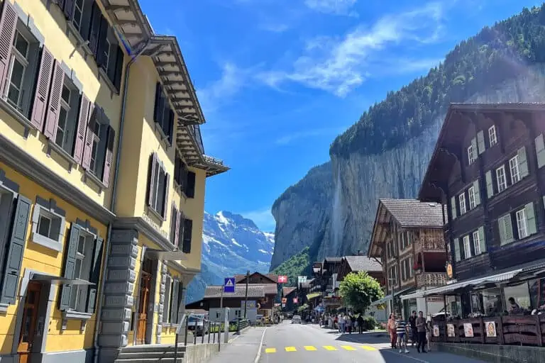 Main street in Lauterbrunnen with chalets and Staubbach Fall