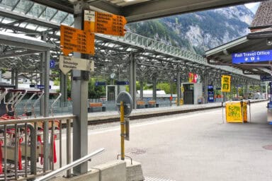 Hiking signposts and rail travel office at the Lauterbrunnen train station.
