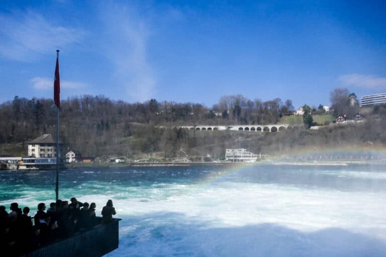 Visitors at a viewing platform suspended above the Rhine Falls.