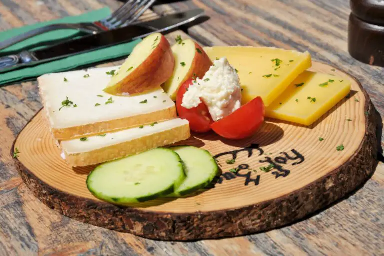 Swiss cheese platter served on tree trunk disk