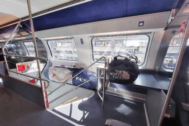 Bags on luggage shelf in Swiss train