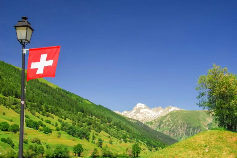 View over Goms valley toward Oberwald and Swiss flag