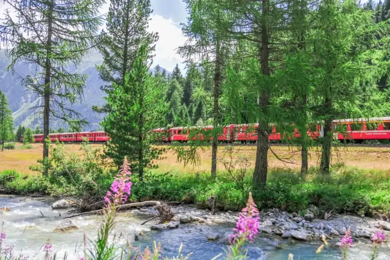 Rhätische Bahn train in Val Bever along river Beverin