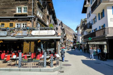 The main street of Zermatt with restaurants, terraces and shops.