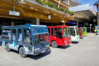 Small electric buses at the train station square of Zermatt.